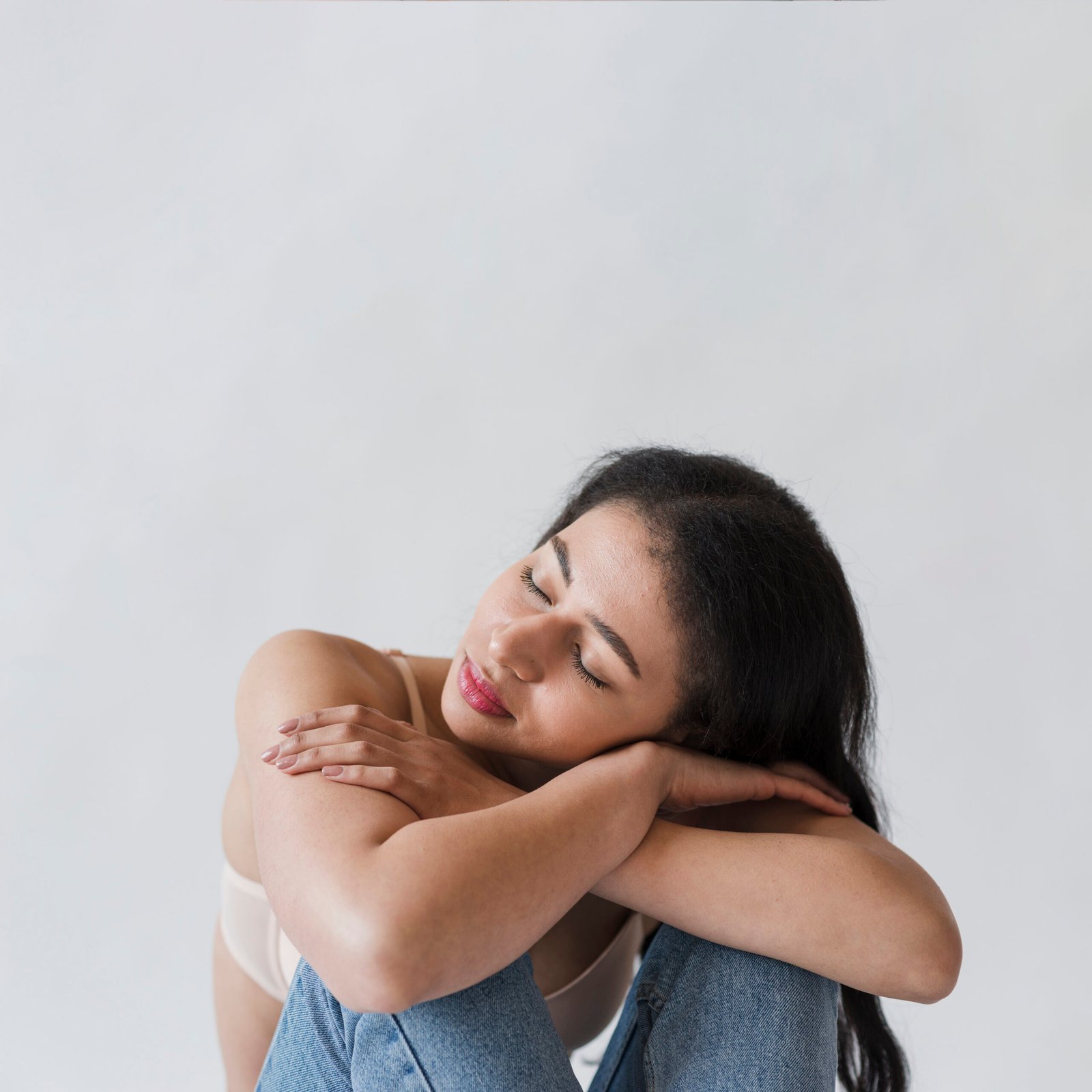 female-lying-head-arms-folded-knees